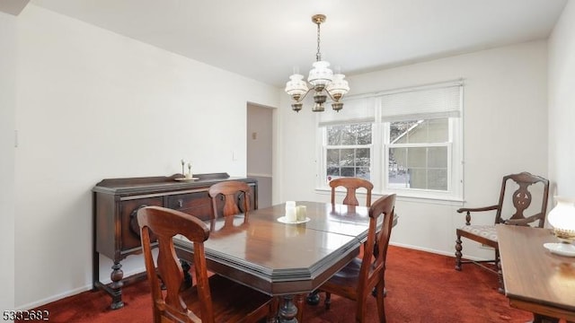 carpeted dining room with a chandelier