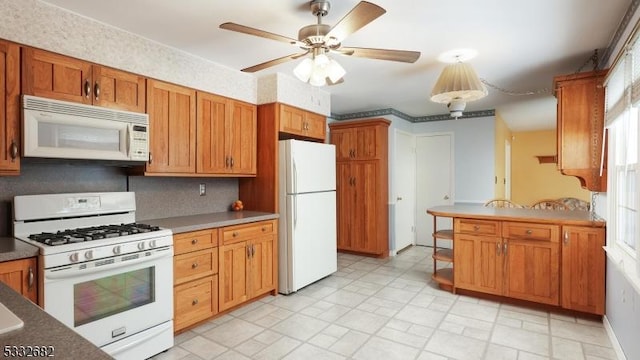 kitchen featuring ceiling fan and white appliances