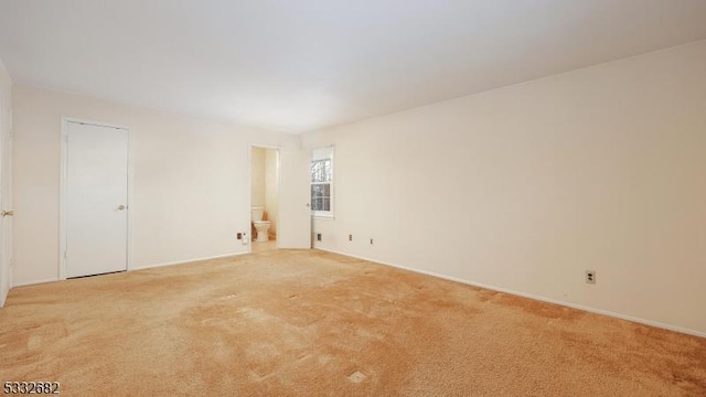 spare room with light colored carpet