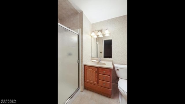 bathroom featuring toilet, an enclosed shower, and vanity