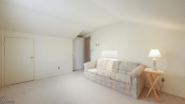 carpeted living room featuring lofted ceiling