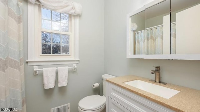 bathroom with toilet and vanity