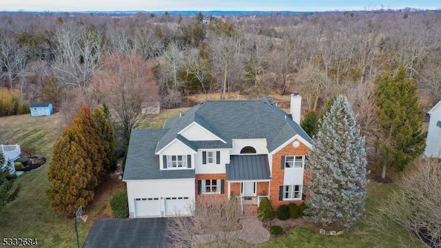 birds eye view of property featuring a view of trees