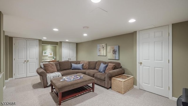 living room featuring recessed lighting, baseboards, and light colored carpet