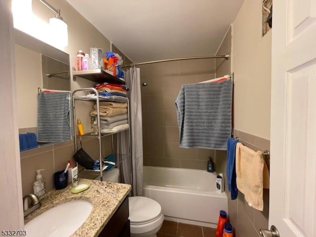 full bathroom featuring tile patterned flooring, shower / bath combination with curtain, vanity, and toilet