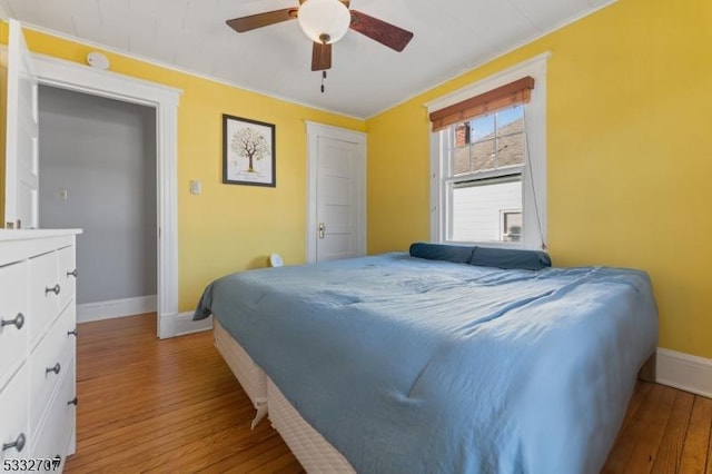 bedroom with ceiling fan and light wood-type flooring