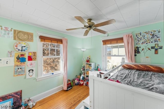 bedroom featuring wood-type flooring and ceiling fan