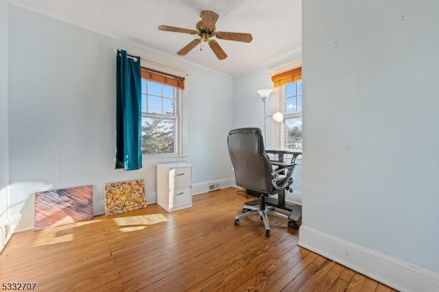 office featuring hardwood / wood-style flooring, ceiling fan, and ornamental molding