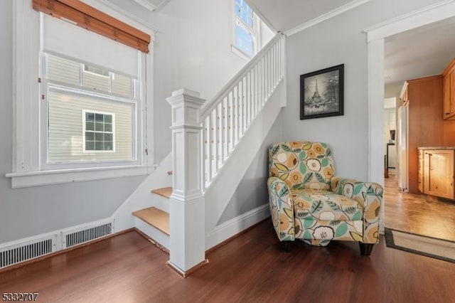 stairs featuring hardwood / wood-style flooring and ornamental molding