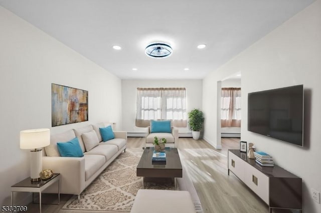 living room with light hardwood / wood-style floors and baseboard heating