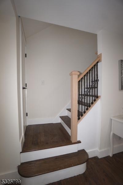 stairway with hardwood / wood-style floors