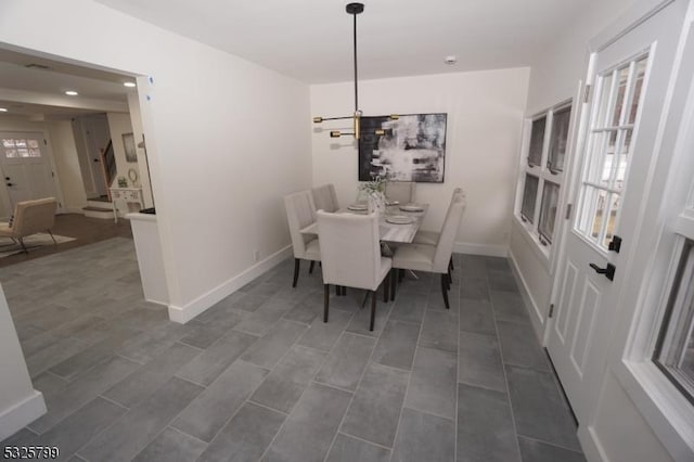 dining area with plenty of natural light and a notable chandelier