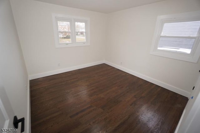 spare room featuring dark hardwood / wood-style floors