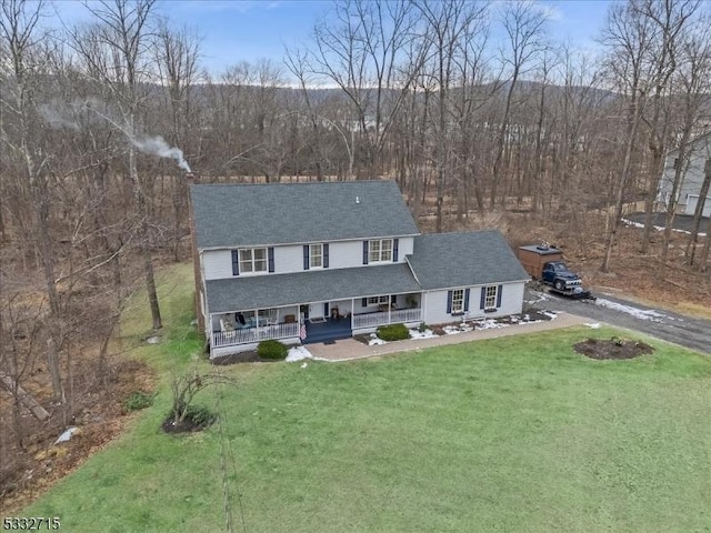 view of front of house with a porch and a front lawn