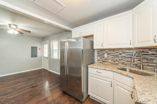 kitchen featuring sink, white cabinetry, stainless steel refrigerator, backsplash, and dark hardwood / wood-style flooring