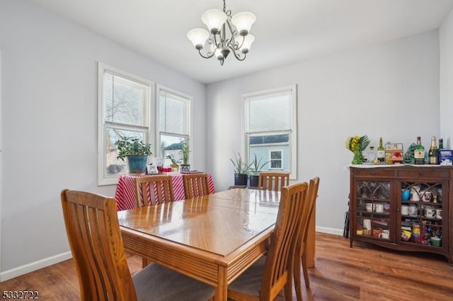 dining room featuring a chandelier and dark wood-type flooring