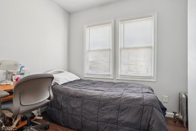 bedroom with dark hardwood / wood-style flooring