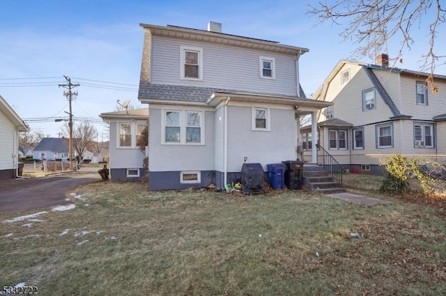 rear view of property with a yard