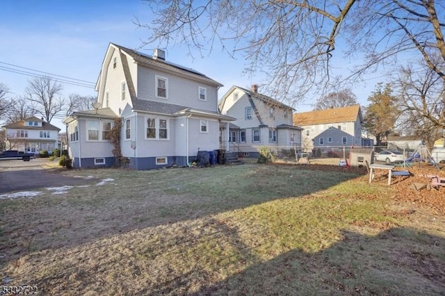 rear view of house with a yard