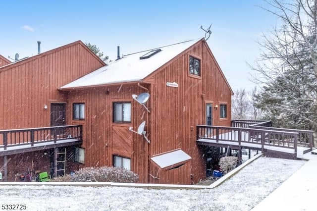 snow covered property featuring a wooden deck