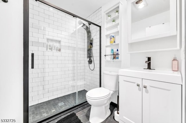 bathroom with toilet, a shower with shower door, and vanity