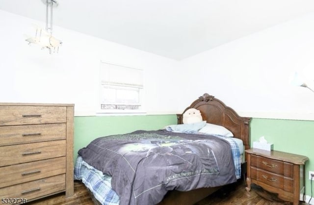 bedroom with dark hardwood / wood-style flooring