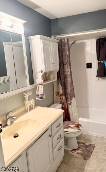 full bathroom featuring toilet, tile patterned floors, shower / tub combo with curtain, and vanity