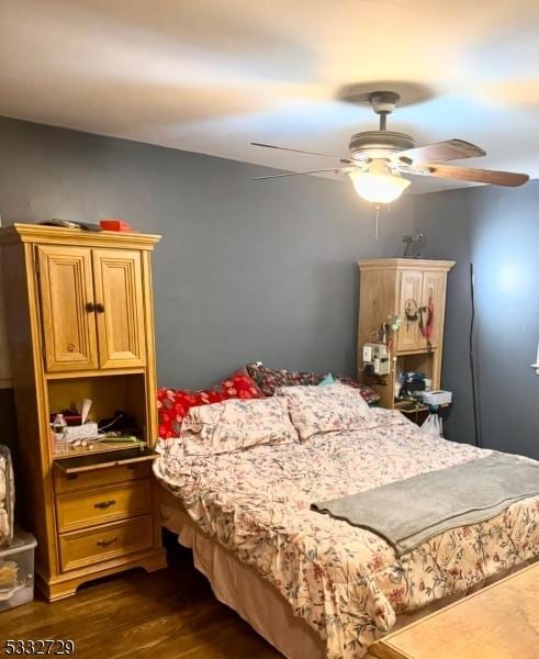 bedroom with ceiling fan and dark hardwood / wood-style flooring