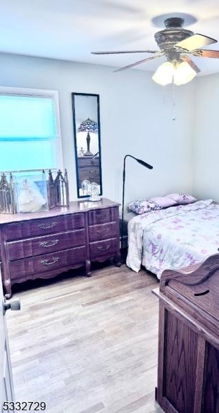 bedroom featuring light wood-type flooring and ceiling fan