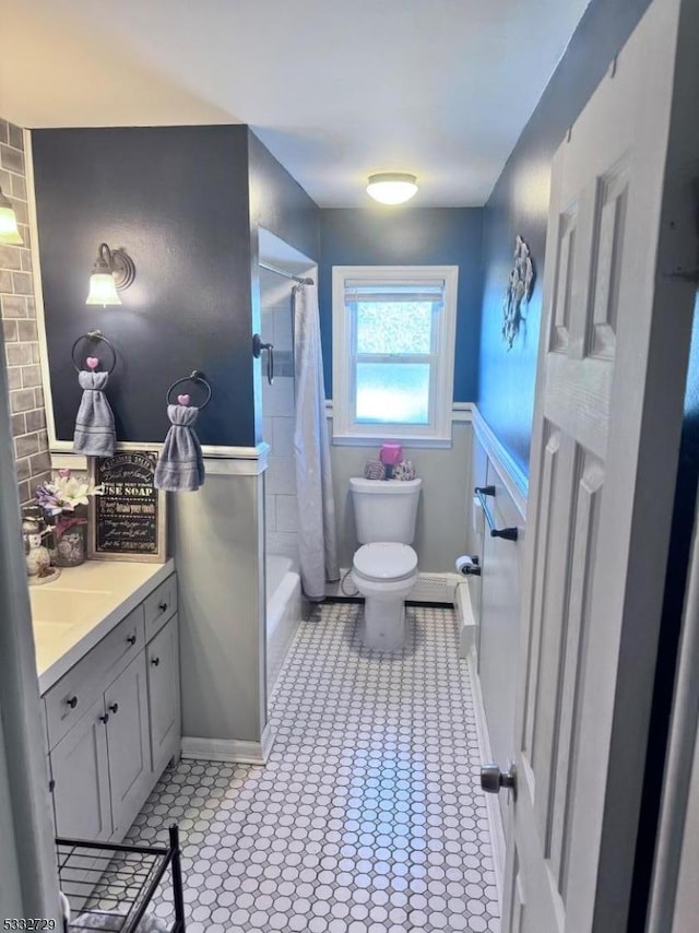 full bathroom with toilet, shower / bath combo with shower curtain, tile patterned floors, and vanity