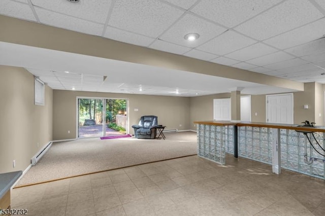 basement featuring light carpet and a baseboard heating unit