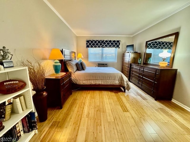 bedroom with ornamental molding and light hardwood / wood-style flooring