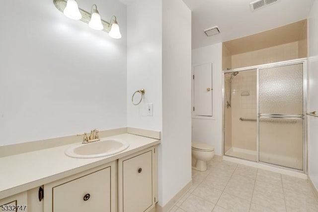 bathroom featuring tile patterned floors, toilet, vanity, and an enclosed shower