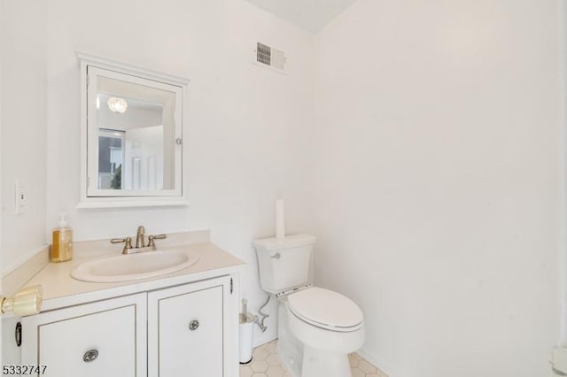 bathroom with toilet and vanity