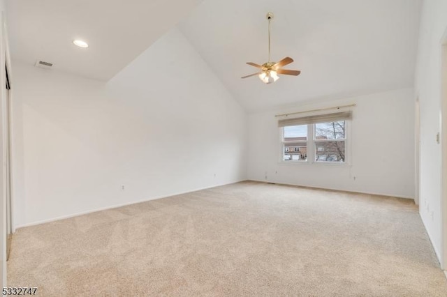 empty room featuring ceiling fan, light colored carpet, and high vaulted ceiling