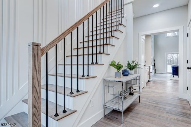 stairway with hardwood / wood-style floors