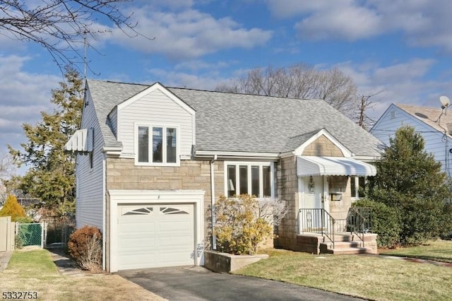 view of front of property featuring a front yard and a garage