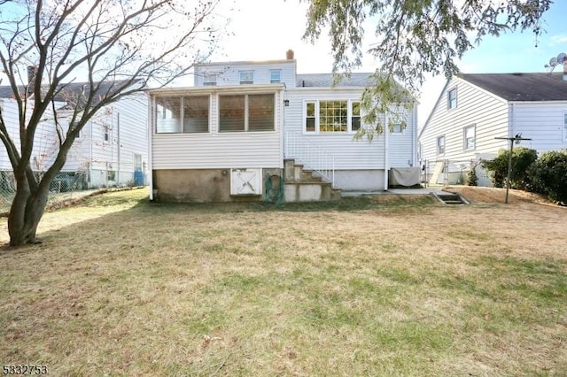 rear view of house with a yard