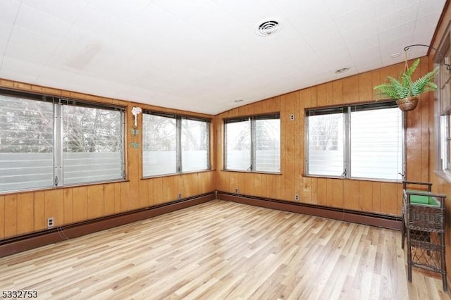 unfurnished sunroom featuring lofted ceiling and a healthy amount of sunlight