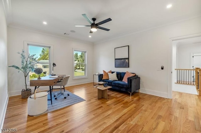 interior space featuring light wood-type flooring, ceiling fan, and ornamental molding