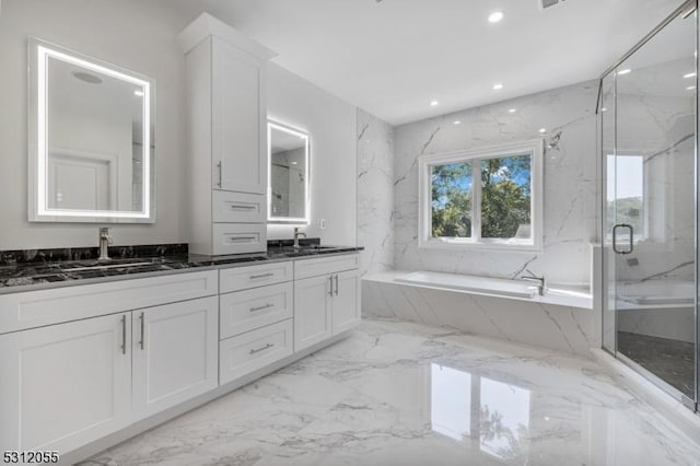 bathroom featuring shower with separate bathtub and vanity