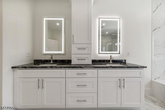 bathroom with vanity and a washtub