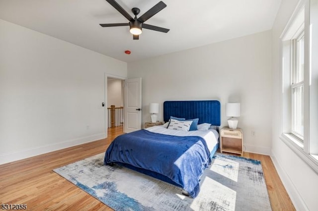 bedroom with hardwood / wood-style flooring and ceiling fan