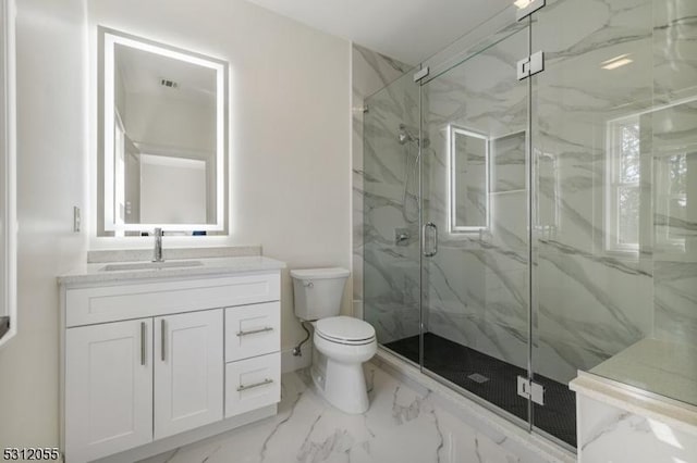 bathroom with vanity, toilet, and walk in shower