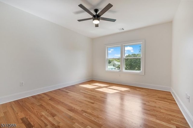 empty room featuring ceiling fan and light wood-type flooring