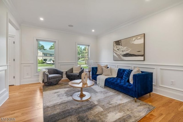 living room with ornamental molding and light wood-type flooring