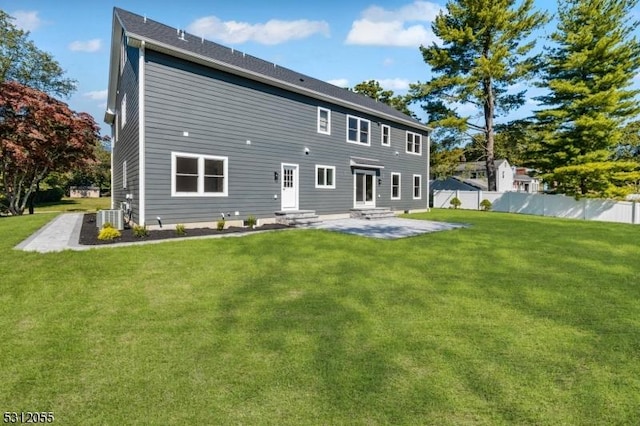 back of house featuring a yard, cooling unit, and a patio area