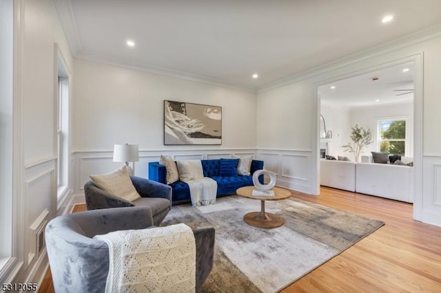 living room featuring hardwood / wood-style flooring and ornamental molding