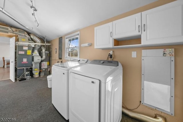 laundry room with cabinets, washing machine and dryer, water heater, and dark colored carpet