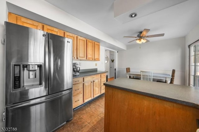 kitchen with stainless steel refrigerator with ice dispenser, dark tile patterned flooring, and ceiling fan